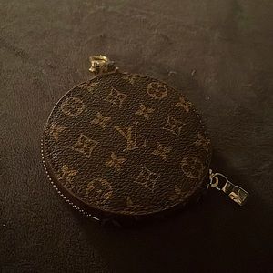 LV change or key holder that clips on to your purse.  Never used